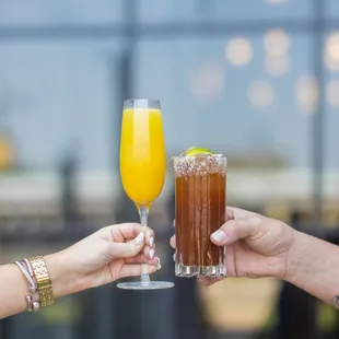 two people toasting with drinks