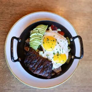 Steak &amp; Hash: skirt steak, two sunny side up eggs, bell peppers, red onion, potato, cilantro sour cream, avocado