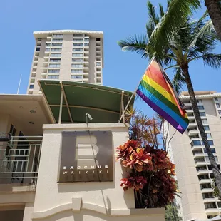 a rainbow flag in front of a building