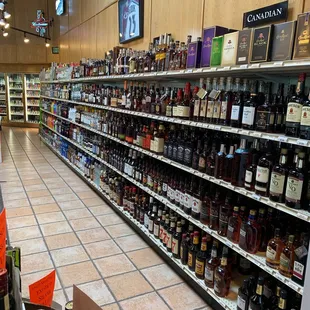 Wall of whiskey , bourbon, rum, and vodka
