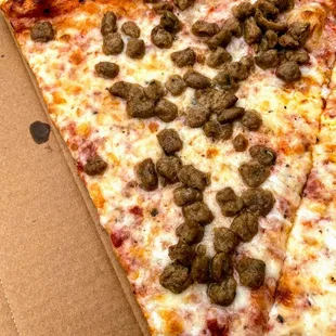 a pizza with sausage and cheese