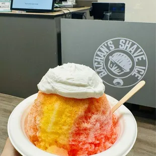 Tropical Sunrise   - Mango, Tiger's Blood, and Guava topped with Li Hing Mui powder and Haupia Cream!