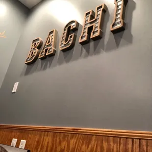 the word bachi on the wall of a restaurant