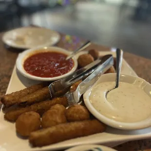 a plate of food with dipping sauce