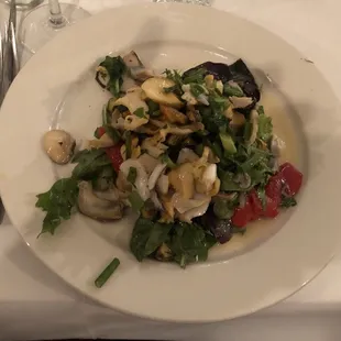 a white plate with a salad on it