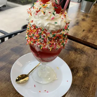 an ice cream sundae with sprinkles and cherries