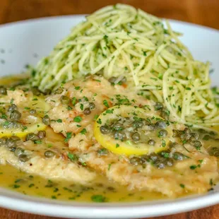 a plate of pasta with lemon and capers