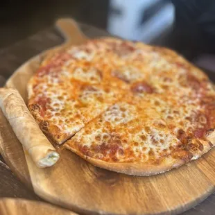 a pizza on a wooden board