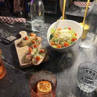 Bruschetta, Caesar salad, and Negroni