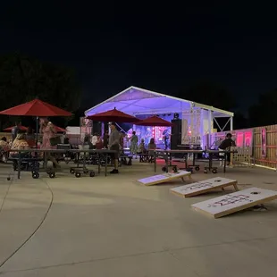 Patio area with live music, cornhole, and ping pong.