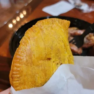 a hand holding a taco