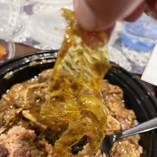 Large plastic piece in Curried Goat Plate