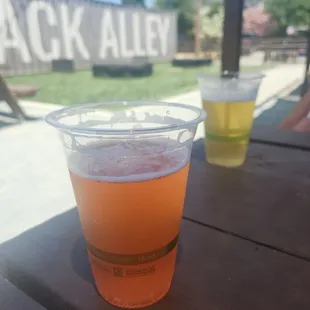 two cups of beer on a picnic table