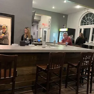 a group of people sitting at a bar