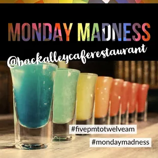 a row of colorful shot glasses with the words monday madness