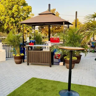 a patio area with a table and umbrella