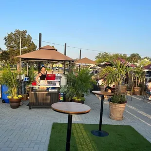 a patio with tables and umbrellas