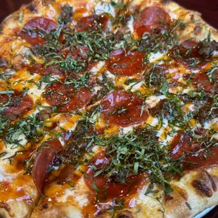 Red sauce, pepperoni, bacon, meatball and basil.