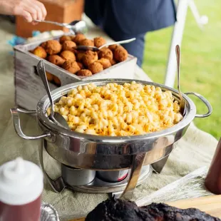 Mac and cheese and hush puppies in the background