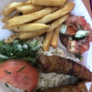Spicy beef over rice plate with two sides: salad and fries
