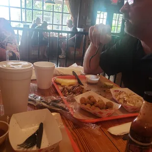 Fried okra, coleslaw, pulled porket,  there was brisket at one point, spicy BBQ sauce, toast, pickle. Craft soda and great atmosphere.