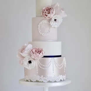 a wedding cake with pearls and flowers
