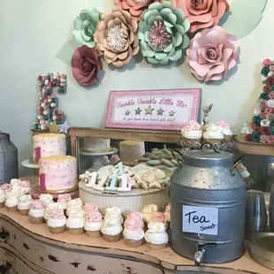 a display of cupcakes and cakes