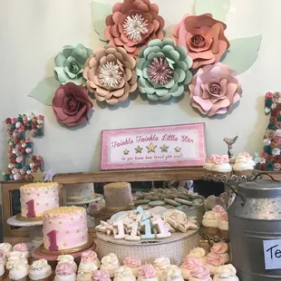 a table of cupcakes and cakes