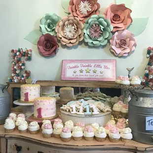 a display of cupcakes and cakes