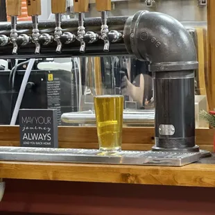 a glass of beer on a bar