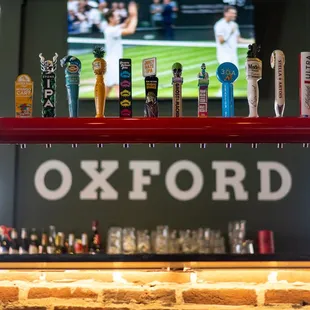 a row of beer taps on a bar