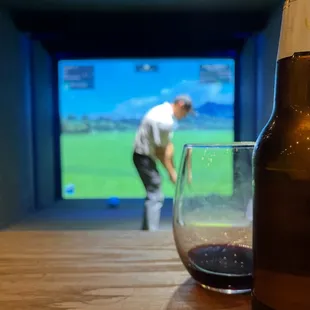 a bottle of beer and a glass of wine