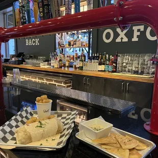 two plates of food on a bar counter