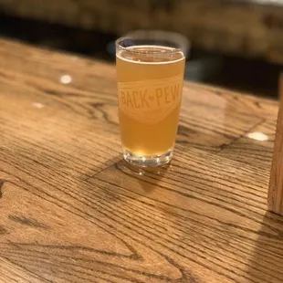 a glass of beer on a bar