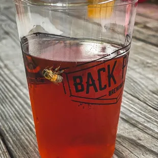 a glass of beer on a wooden table