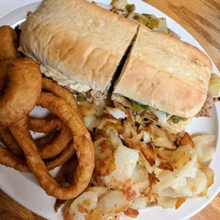 Smokehouse special. (This is a Philly Cheese steak with pulled pork or chicken). Onion rings and fried potatoes aka taters.