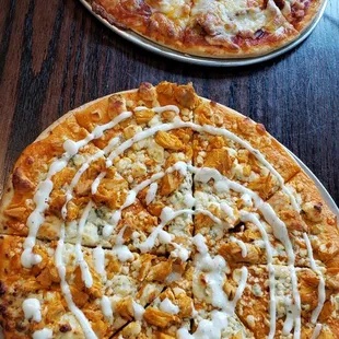 two pizzas on a table