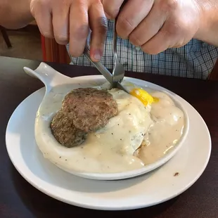Smothered biscuit meal: biscuits &amp; gravy, sausage patties, home fries with onions &amp; peppers.