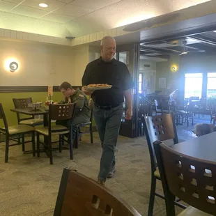 My friend Bill bringing over his hamburger &amp; fries. Hubby used to work for Bill.