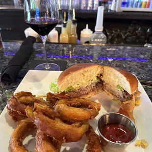 Brazilian burger with onion rings.