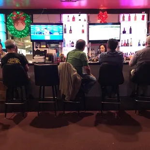 a group of people sitting at a bar