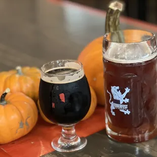 a glass of beer and pumpkins