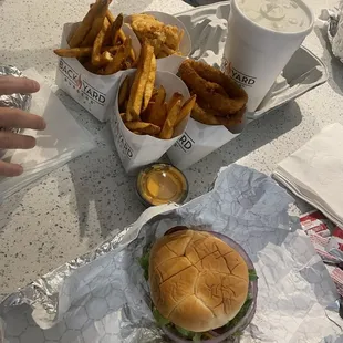 We got the Bacon Cheddar Burger and double classic with a bunch of fries and onion rings the garlic park fries are sooo good Fire