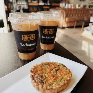 a plate of food and two cups of coffee