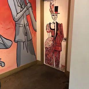 The art on the unisex bathroom door