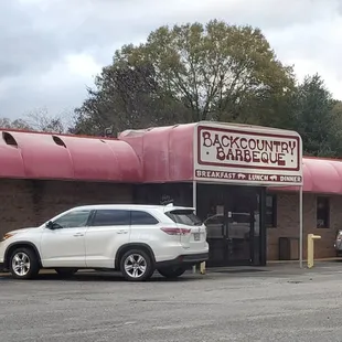 cars parked in front of a restaurant