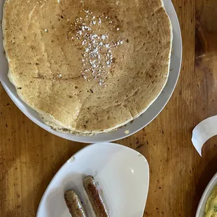 Gigantic chocolate chip pancake and a side of sausage.  Anyone that can eat 3 of these is amazing!!