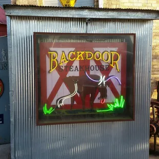 The sign at the entrance of the Back Door Steakhouse.