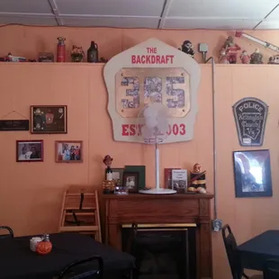 A wall full of firemen toys and trinkets