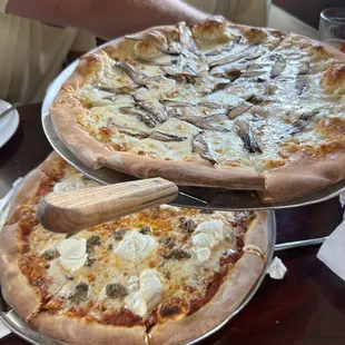 Truffle pizza (top) meatball ricotta pizza on bottom.